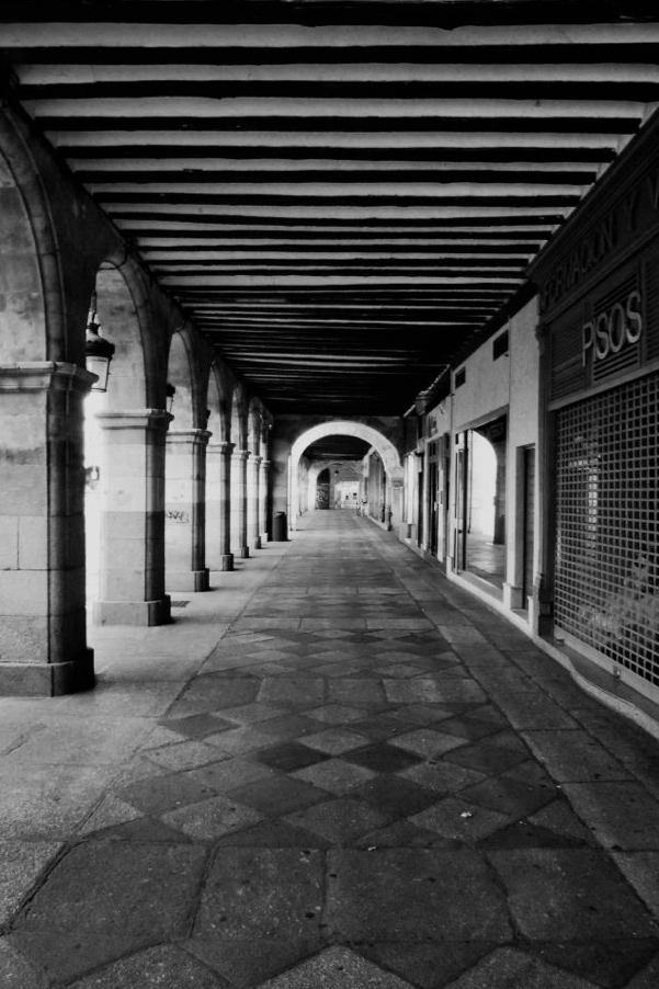 “Part of the collonaded walkway that surrounds the Plaza Mayor at Salamanca.”